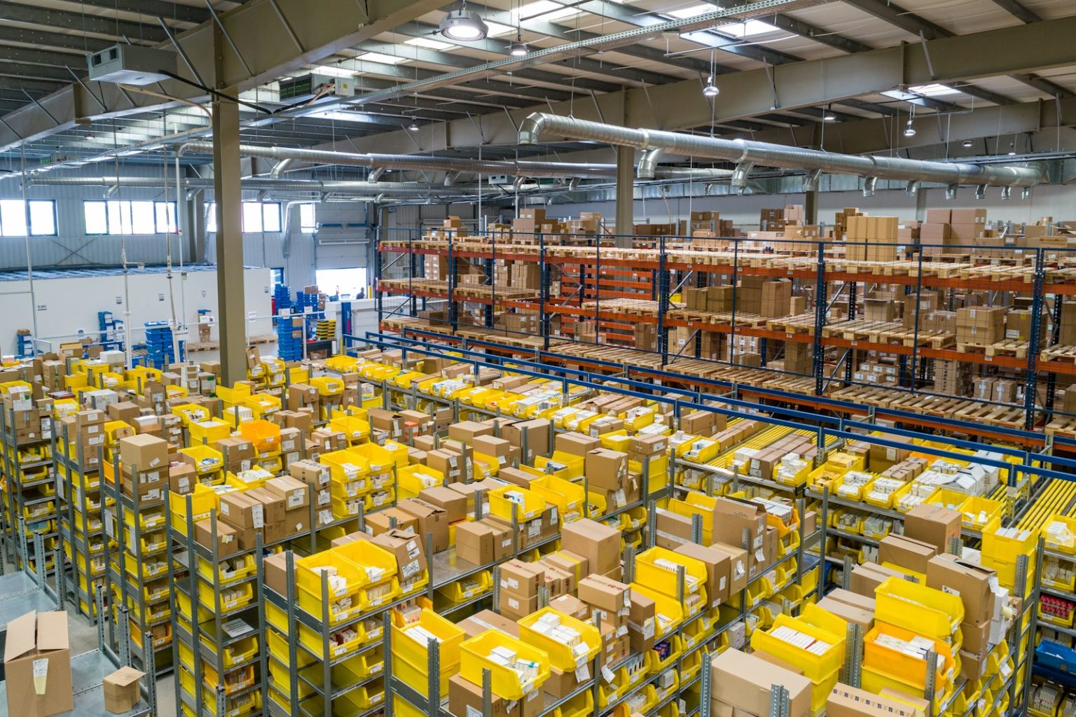 Wholesale order preparation area with stacked crates and pallets ready for dispatch