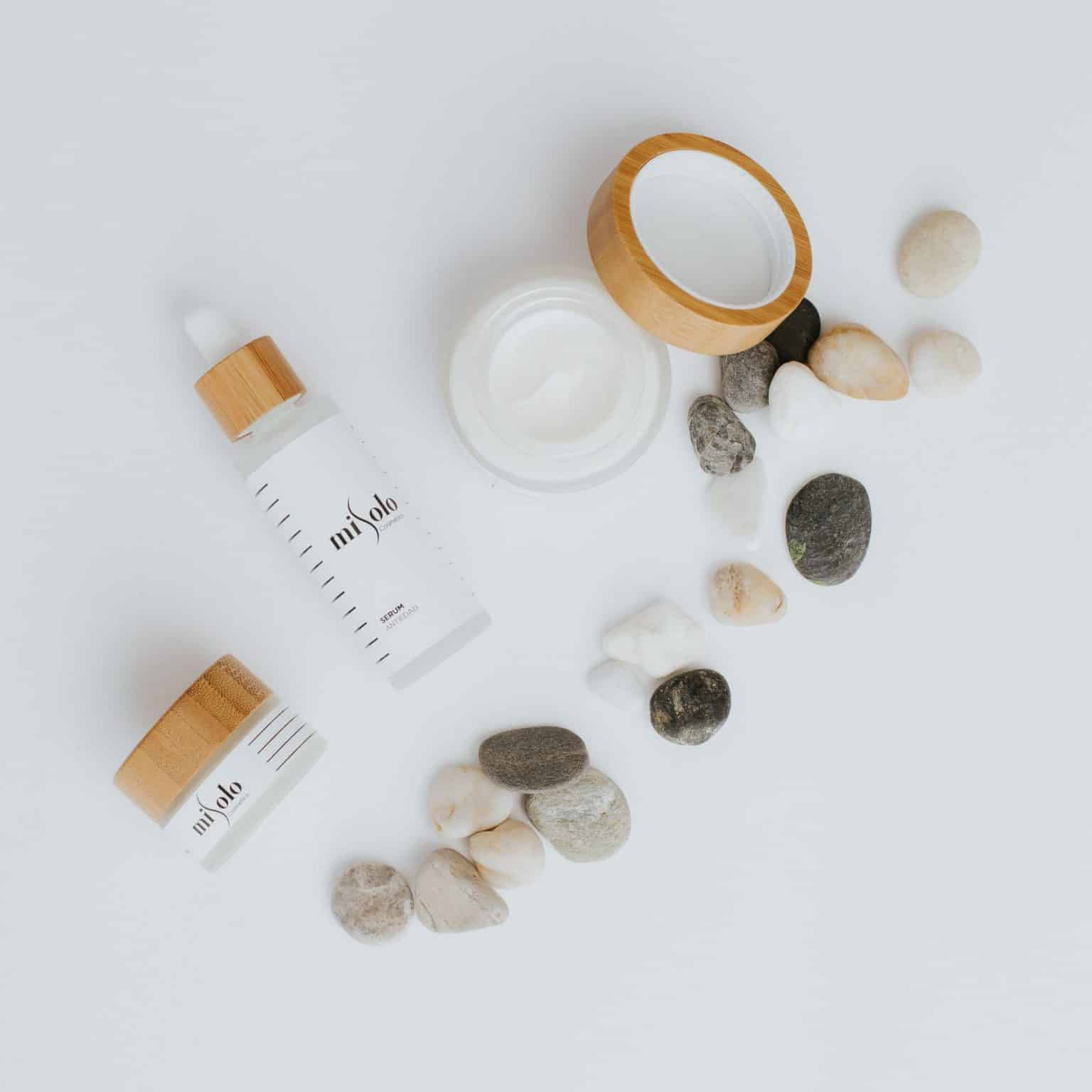 Skincare and cosmetics products arranged on a light surface