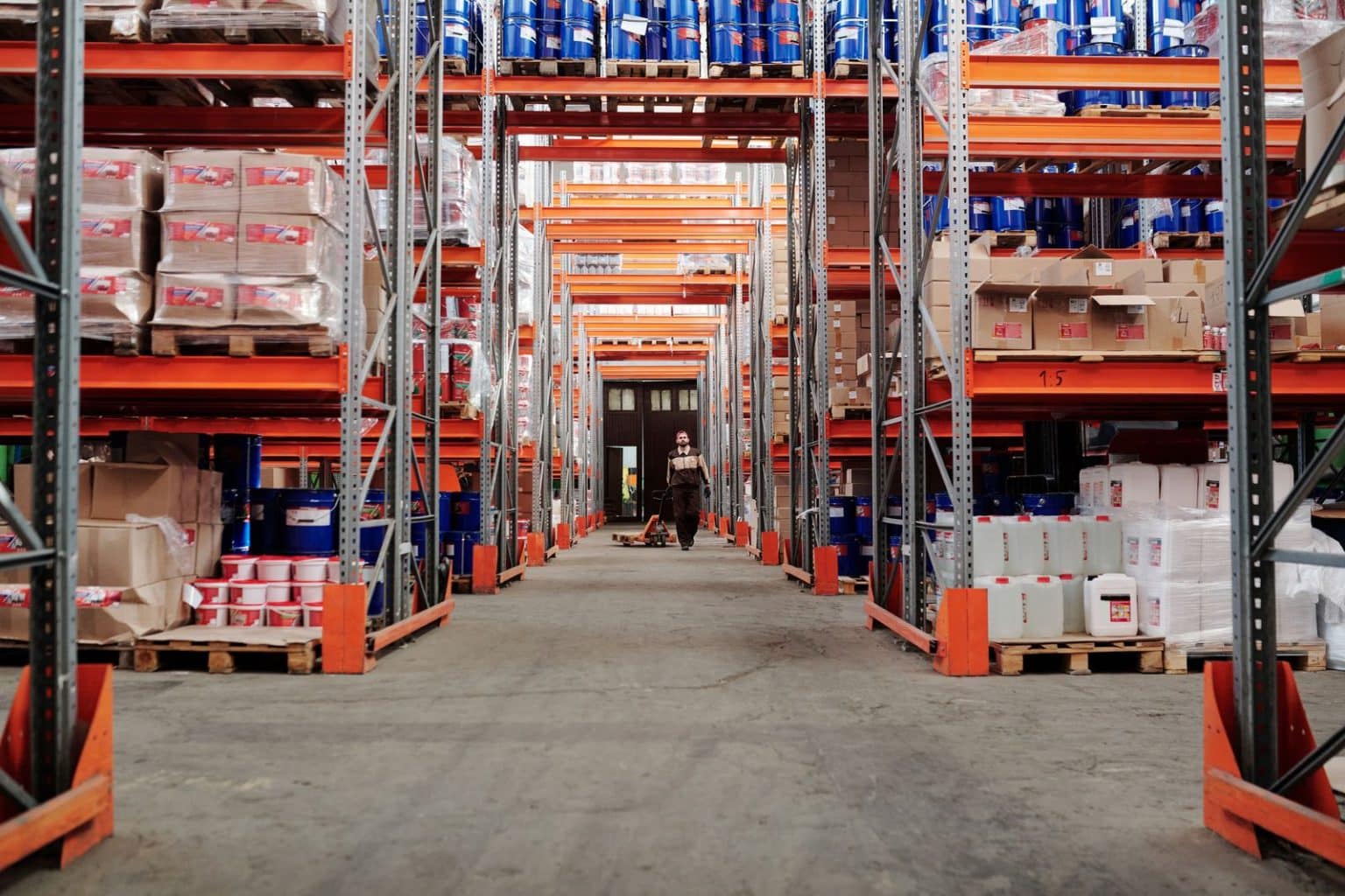 Distribution warehouse with palletised stock on tall metal racking